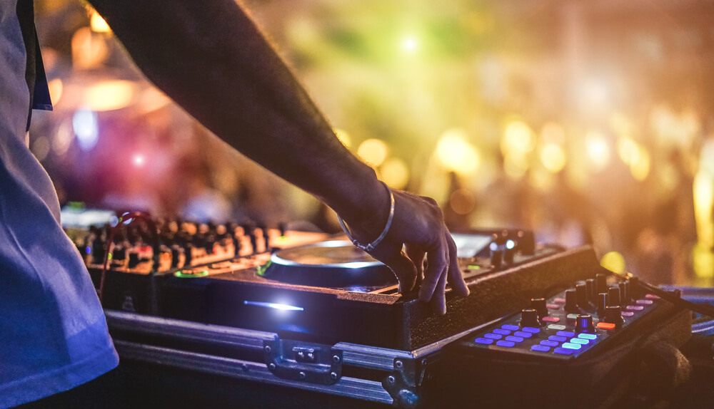 DJ playing music at a club, a popular Aruba nightlife activity
